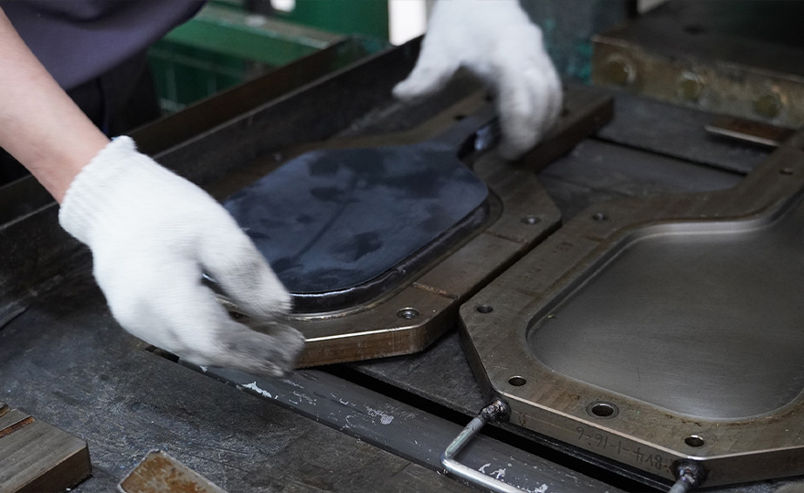 Pickleball paddle positioned in production tooling